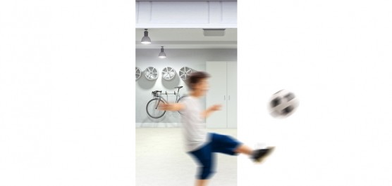 Garçon qui joue au ballon dans un garage